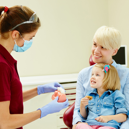 child and mother with dentist